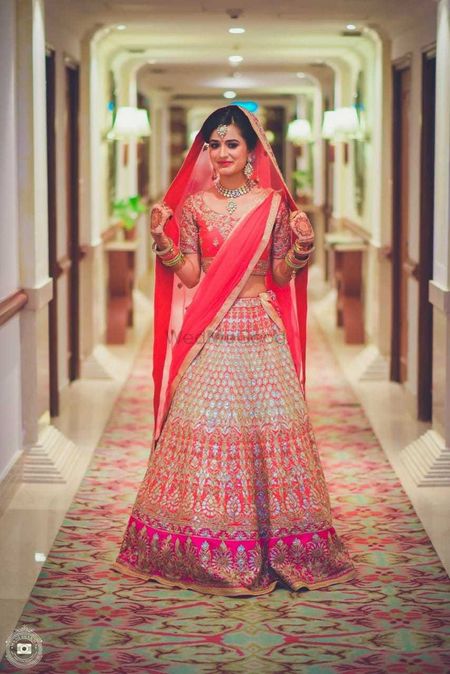 Photo of Stunning bride wearing ombre lehenga for the wedding