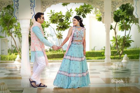 Coordinated bride and groom in light blue mehendi outfits 