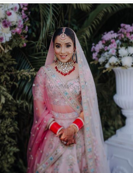 Photo of Bridal portrait with light pink lehenga and blue embroidery with ombre dupatta