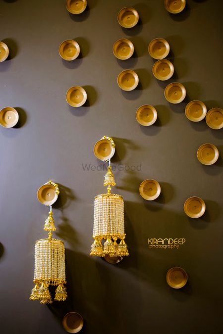 Unique golden bridal kaleere hanging on wall