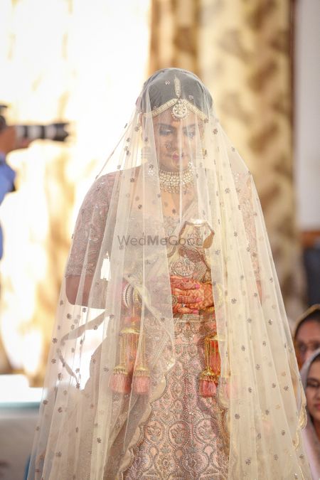 Sikh bride entering wearing veil 