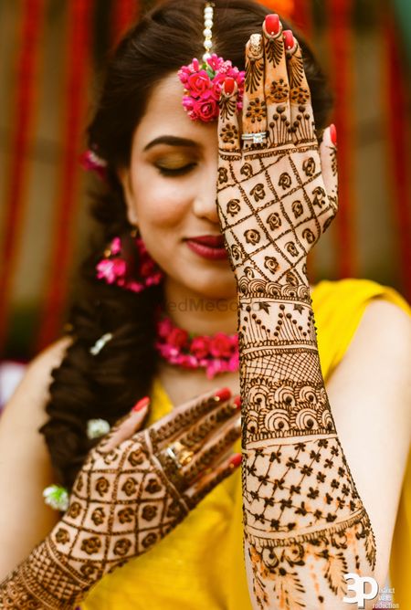 Photo of Bride flaunting her back hand mehndi design