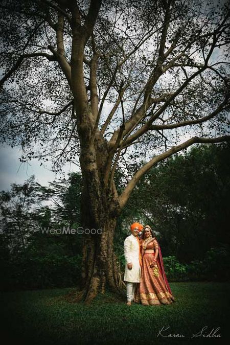 bride and groom under a tree