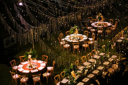 Long table setting with fairy lights all over 