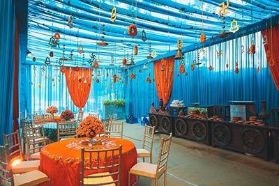 Photo of Mehendi decor idea with orange and blue decor
