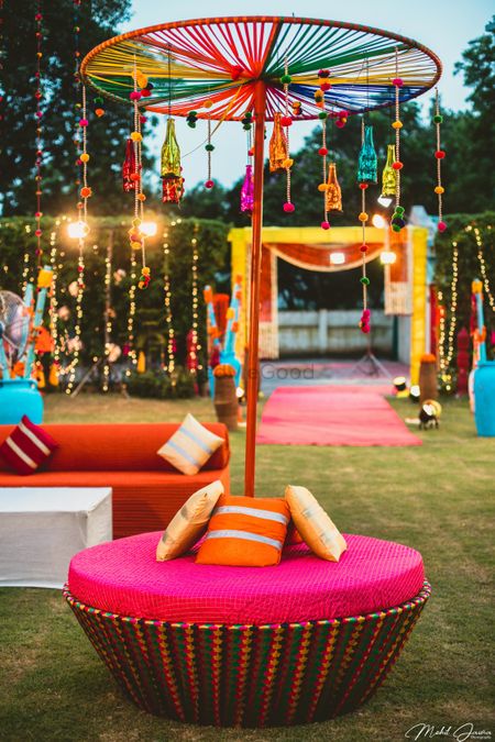 Seating canopy idea for mehendi with hanging bottles 