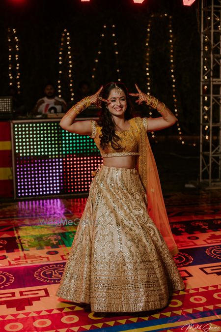 Dancing bride in dull gold lehenga 