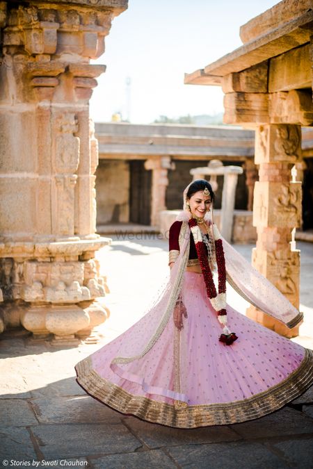 Photo of Twirling bride in simple pink lehenga