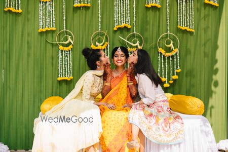 A bride on her haldi function with her bridesmaids