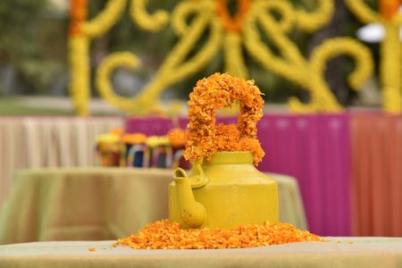Photo of yellow teapot as wedding centerpiece