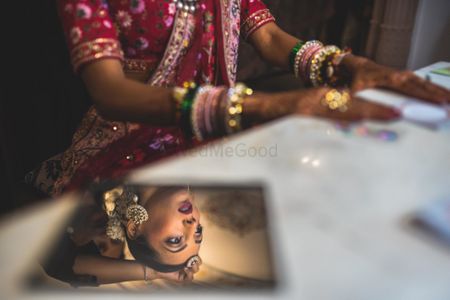 Creative bride looking in mirror shot 