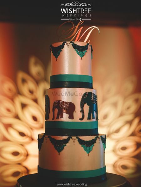 Unique fort wedding cake with elephants in green and white