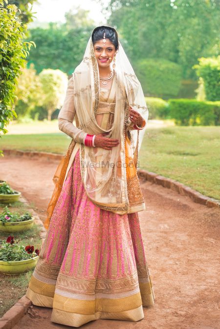 pink bridal lehenga with off white blouse