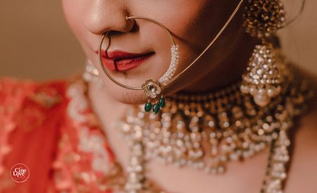 Photo of Bridal Nath with green beads close up shot