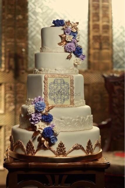 Photo of multi story white and purple wedding cake