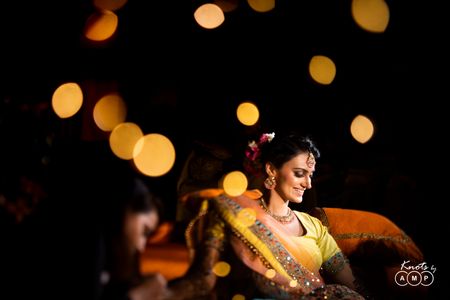Bride on mehendi with bokeh photography 