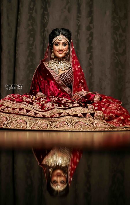 Reflection shot with bride in maroon lehenga 