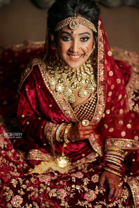 Heavy bridal look in maroon velvet lehenga