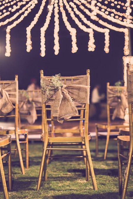 Photo of wooden chairs with burlap cloth