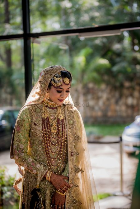 Muslim bridal look with gold anarkali and lots of jewellery