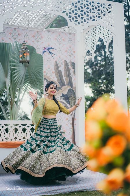 Bride twirling wearing green mehendi lehenga 
