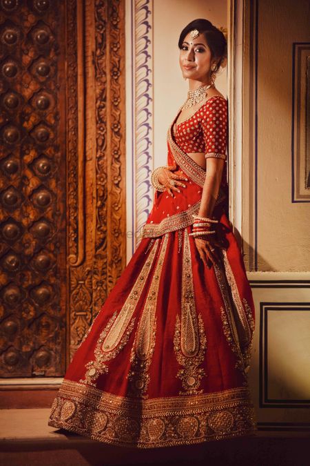 Minimal bridal lehenga with red and gold work 