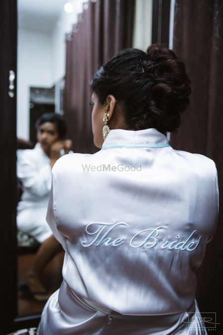 Photo of Bride getting ready accessory white silk robe