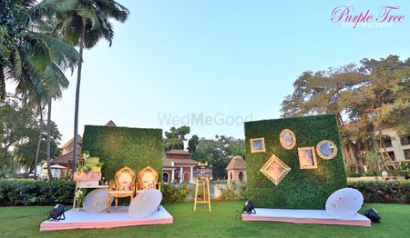 Photo of Photobooth decor with green ferns backdrop and gold