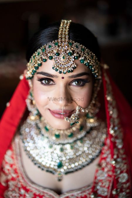 Bridal mathapatti and nath with green beads