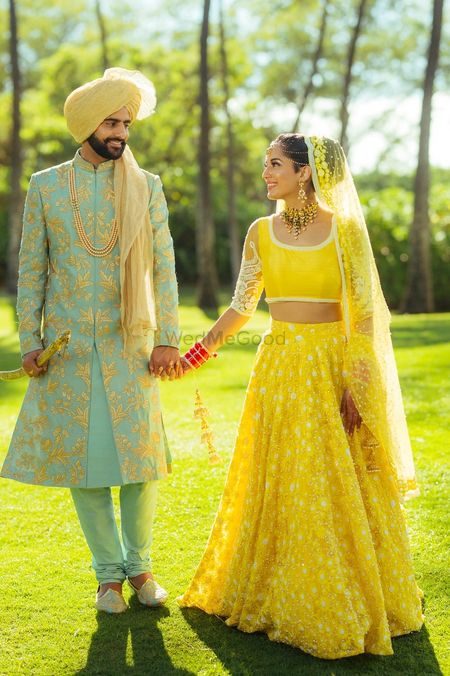Yellow bridal lehenga and turqyiuse sherwani