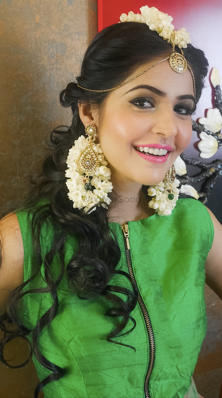 Floral white jewellery on bride, side swept curls hairstyle