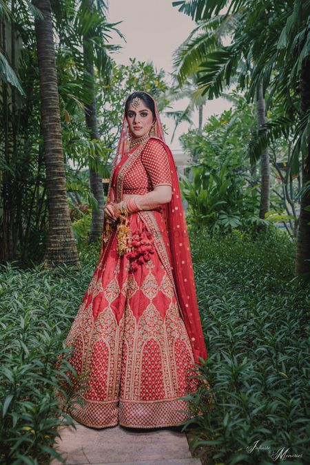Bride in an embroidered red bridal lehenga 