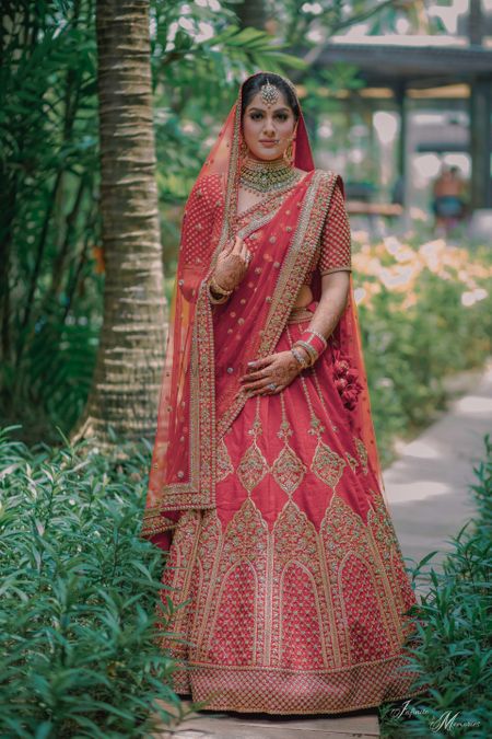 Bride in red with embroidered bridal lehenga 