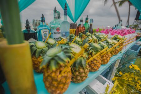 Pool party bar idea with drinks in pineapples 
