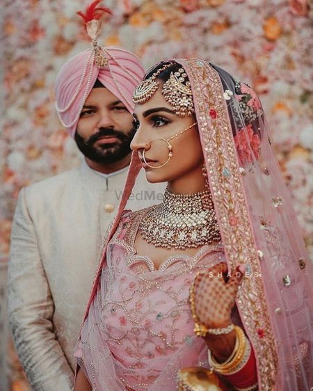 Sikh couple in light pink outfits and unique jewellery