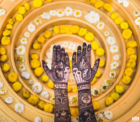 Photo of A stunning shot captured of the bridal mehendi with a perfect decor element in the background