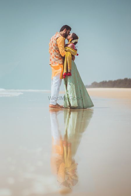 Couple on beach wedding kissing shot 