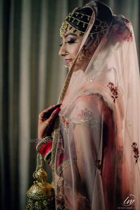 A bride smiling through her veil.  