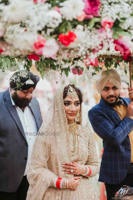 Bride in silver under phoolon ki chadar 