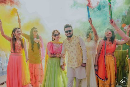Mehendi couple entry with guests holding smoke sticks 
