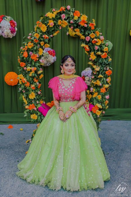 Bright pink and light green lehenga for mehendi on bride 