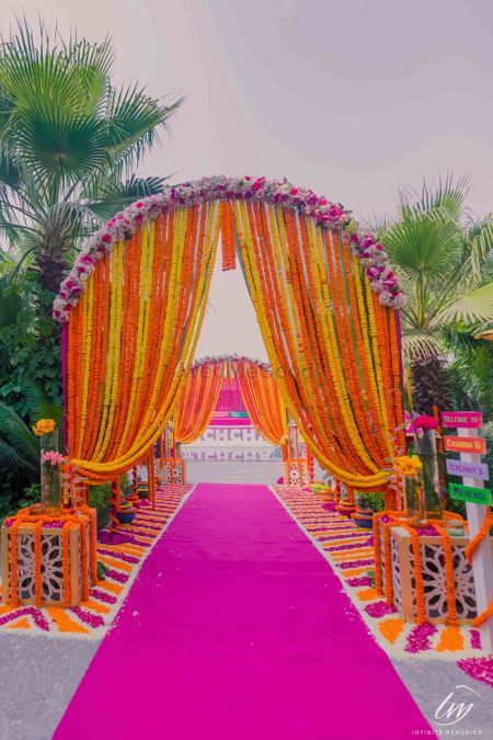 Mehendi entrance decor with floral archway