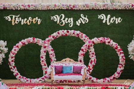 Engagement stage decor with botanical wall and floral installment 