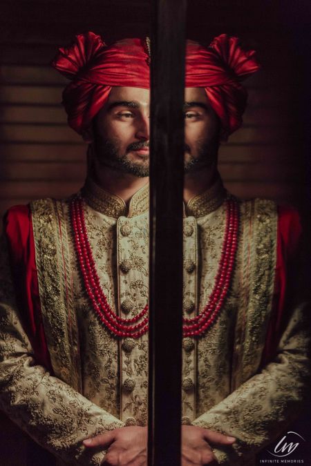 Modern groom portrait in red safa and necklace 