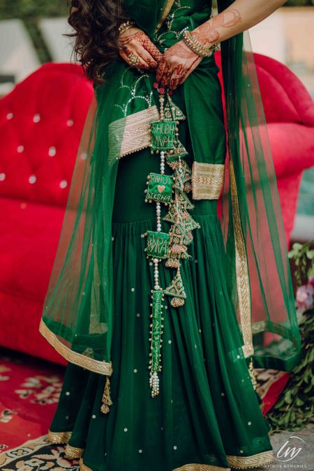 Personalised bridal lehenga in dark green with latkans 