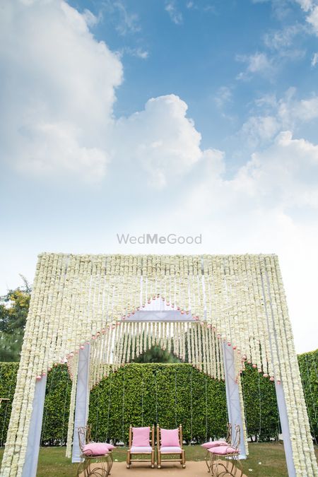 Mandap decor with white suspended flowers