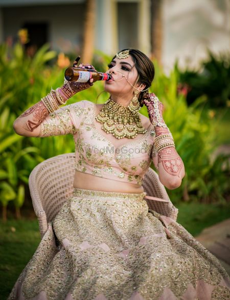 Photo of Bride with alcohol bottle in her hand