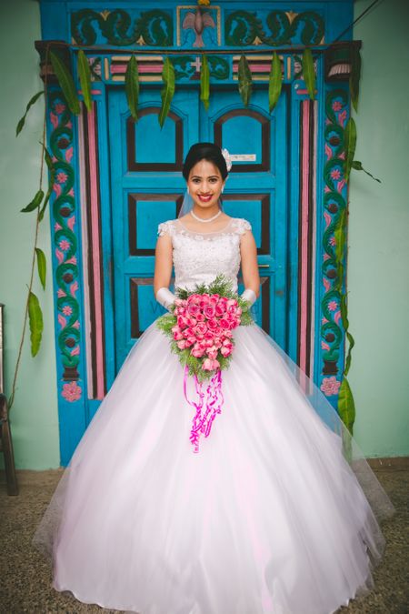 White Wedding Gown and Pink Wedding Bouquet
