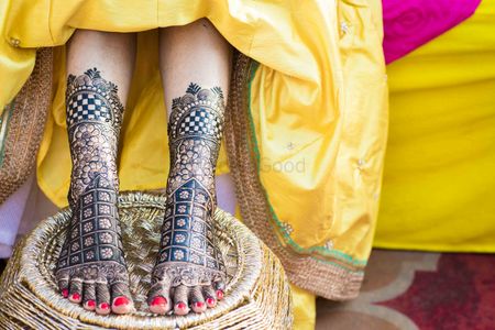 A bride with her feet decorated with mehendi
