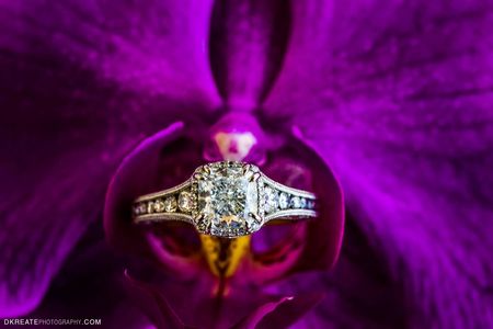 engagement ring on a purple flower
